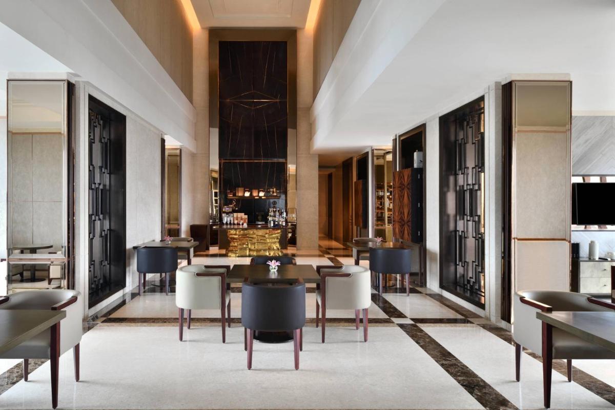 a dining room with a table and chairs at JW Marriott Hotel Kolkata in Kolkata