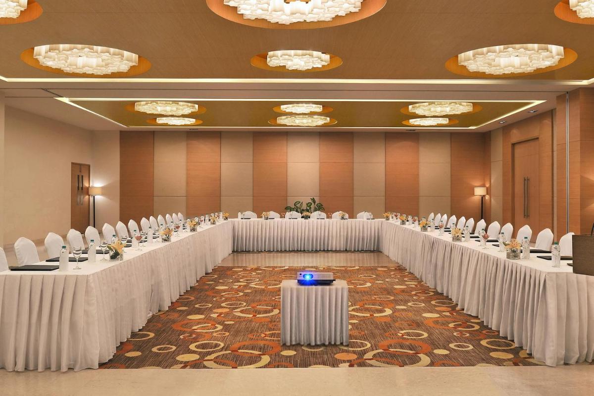 a large room with rows of tables and chairs at Four Points by Sheraton Hotel and Serviced Apartments Pune in Pune