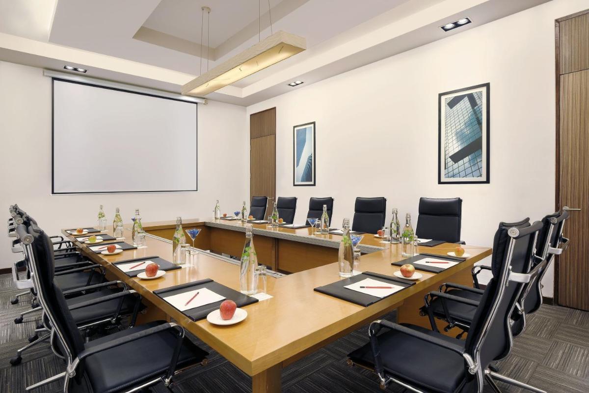 a large conference room with a large table and chairs at Four Points by Sheraton Hotel and Serviced Apartments Pune in Pune
