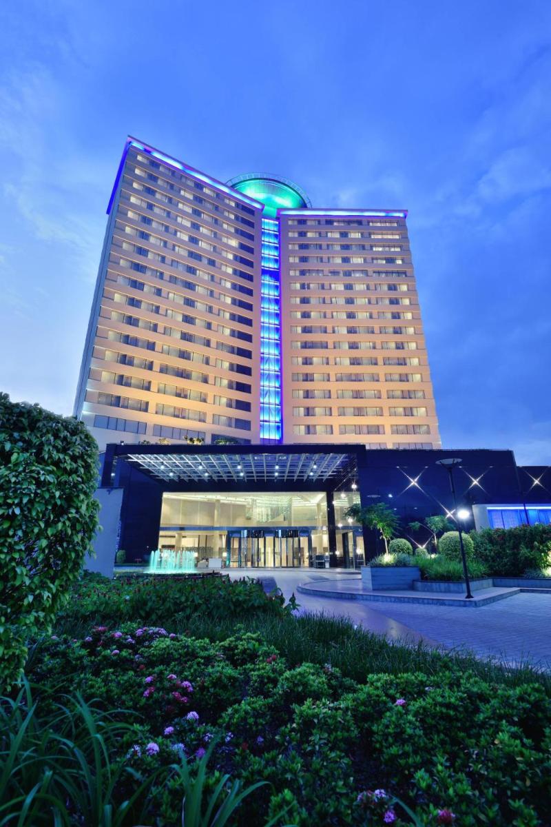 a large hotel building with a green dome on top at Kochi Marriott Hotel in Cochin