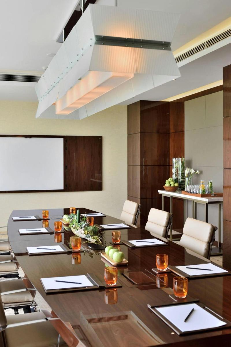 a large conference room with a long table and chairs at Kochi Marriott Hotel in Cochin