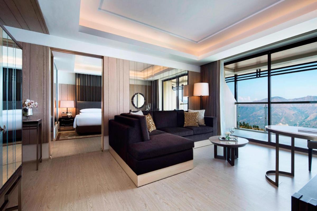 a living room with a couch and a bed at JW Marriott Mussoorie Walnut Grove Resort & Spa in Mussoorie