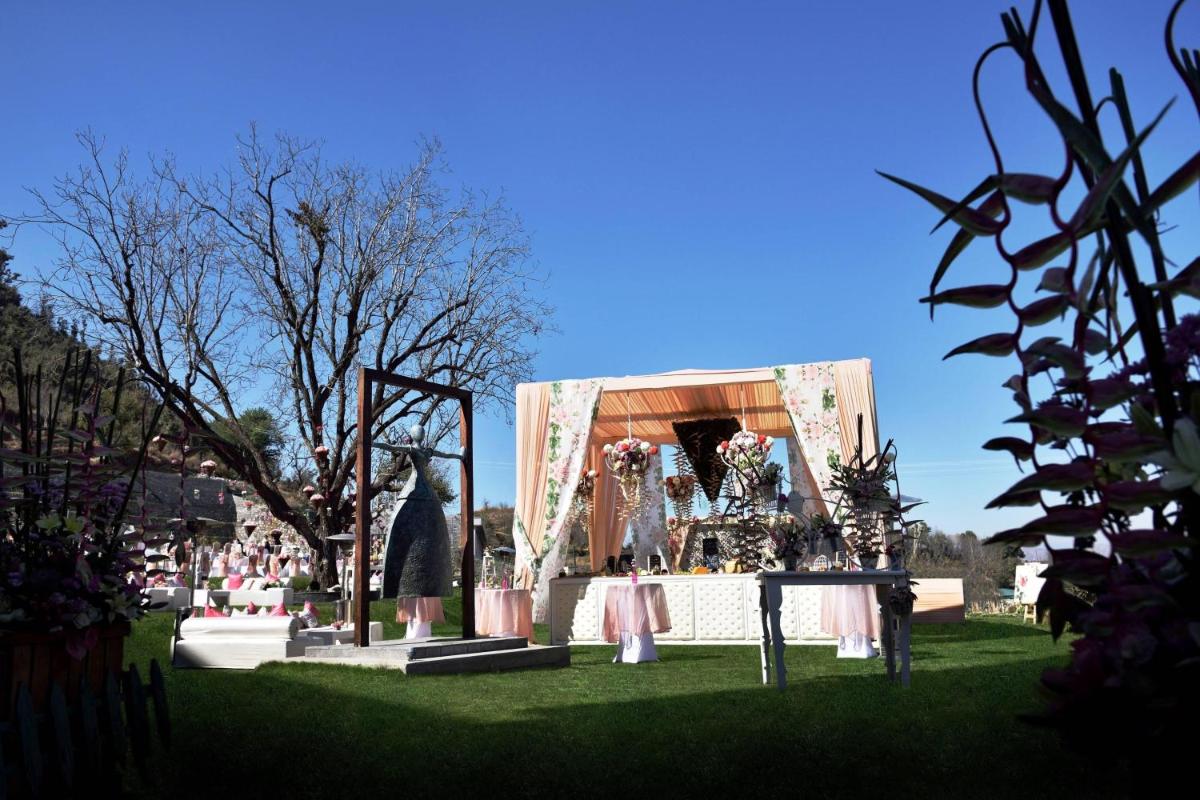 a exhibit in a park with a lot of flowers at JW Marriott Mussoorie Walnut Grove Resort & Spa in Mussoorie