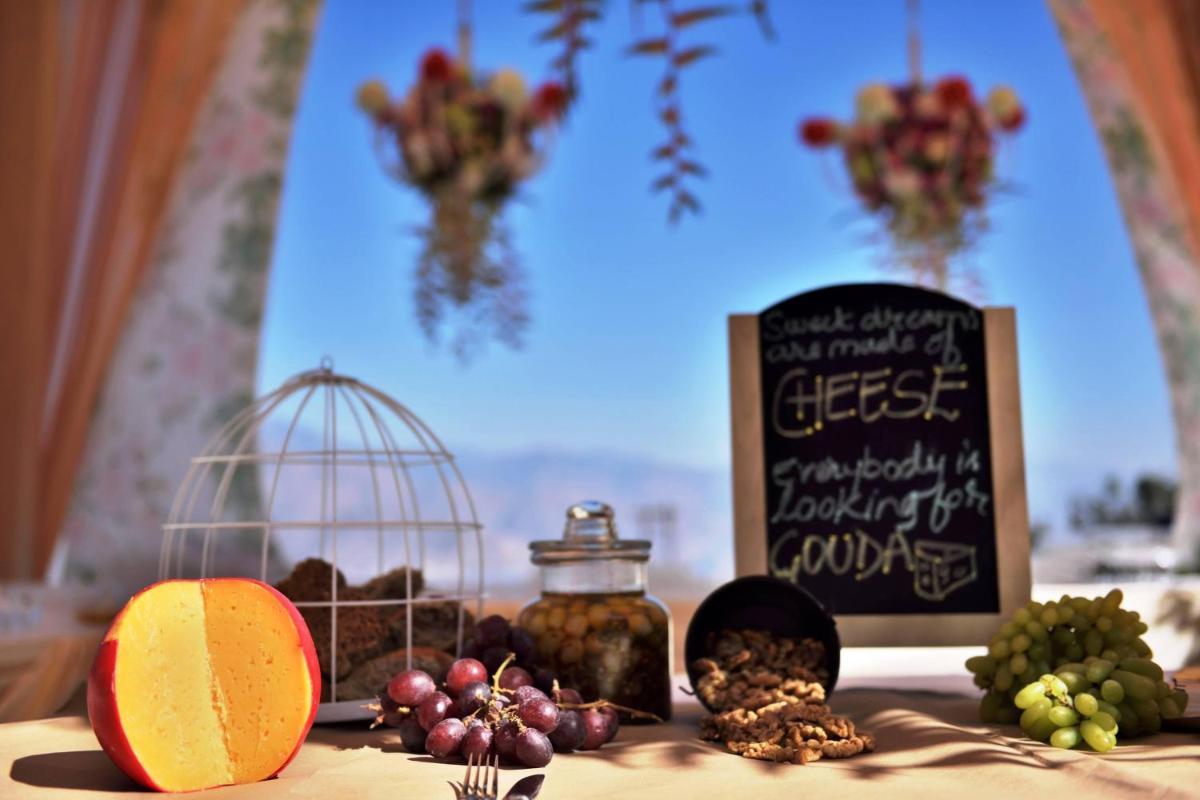 a table with fruits and a sign and a bird cage at JW Marriott Mussoorie Walnut Grove Resort & Spa in Mussoorie
