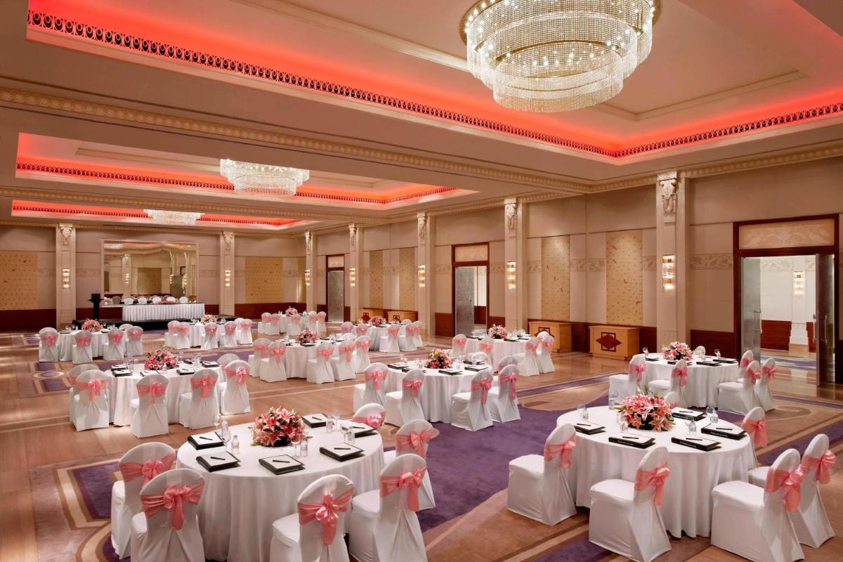 a large banquet hall with white tables and chairs at ITC Gardenia, a Luxury Collection Hotel, Bengaluru in Bengaluru a large banquet hall with white tables and chairs at ITC Gardenia, a Luxury Collection Hotel, Bengaluru in Bengaluru