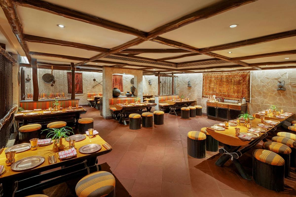 a restaurant with tables and chairs in a room at ITC Sonar, a Luxury Collection Hotel, Kolkata in Kolkata