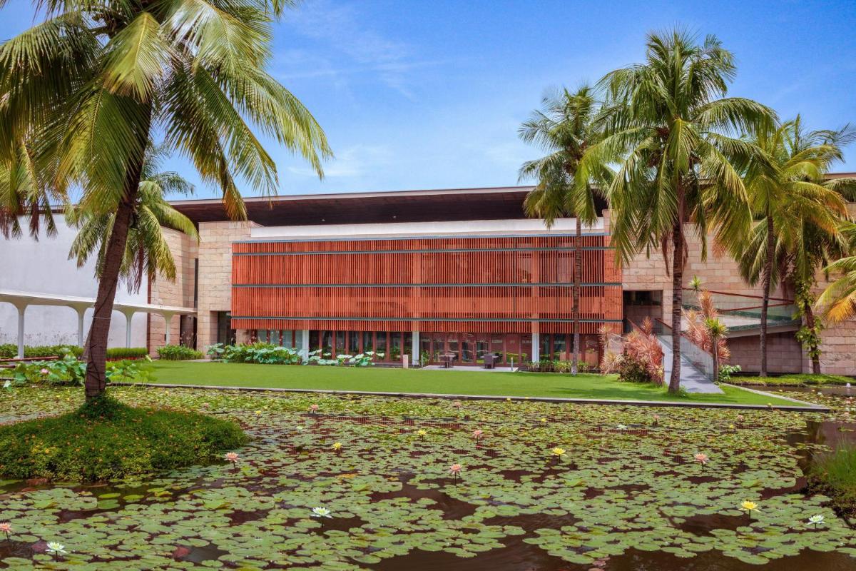 a building with palm trees in front of it at ITC Sonar, a Luxury Collection Hotel, Kolkata in Kolkata