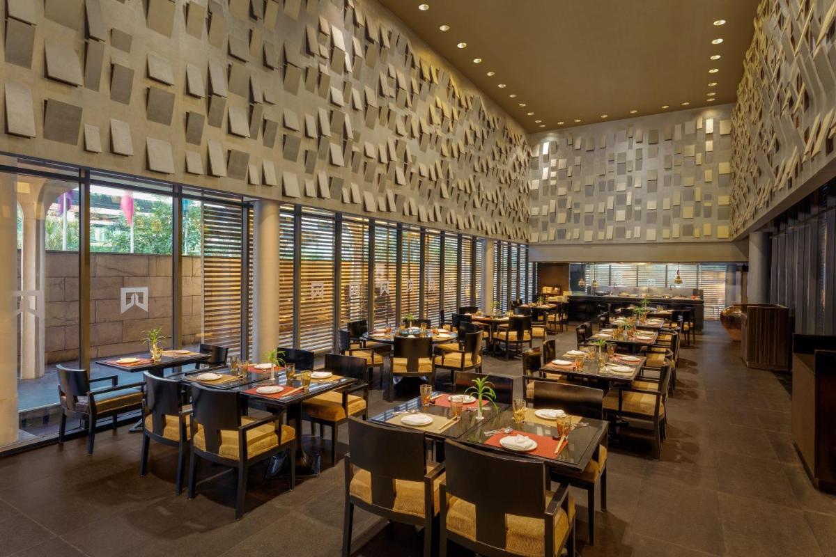a restaurant with tables and chairs in a room at ITC Sonar, a Luxury Collection Hotel, Kolkata in Kolkata