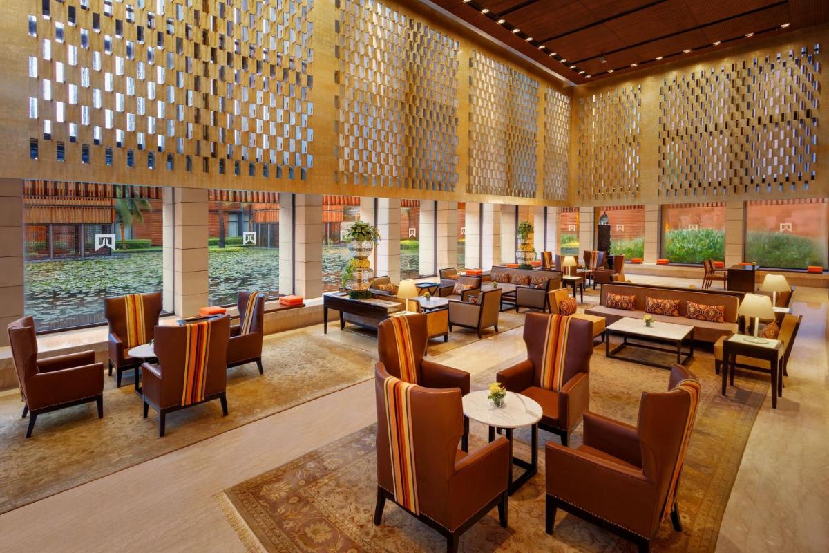 a restaurant with tables and chairs in a building at ITC Sonar, a Luxury Collection Hotel, Kolkata in Kolkata