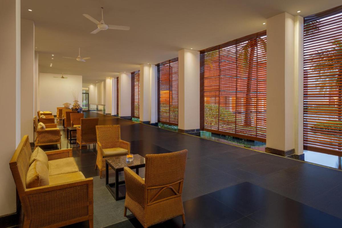 a restaurant with chairs and tables and windows at ITC Sonar, a Luxury Collection Hotel, Kolkata in Kolkata