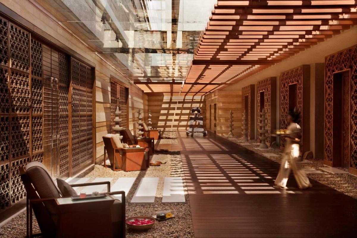 a person walking down a hallway in a building at JW Marriott Pune in Pune