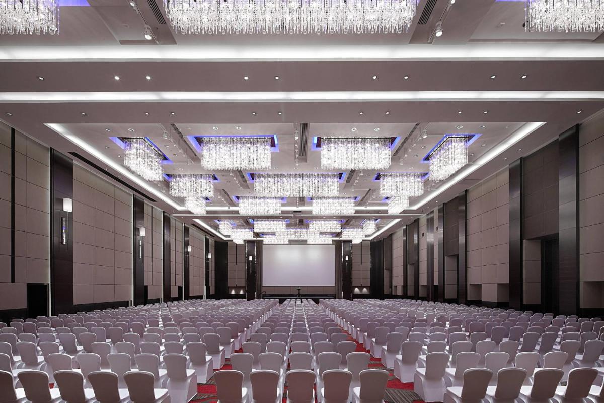 an empty hall with chairs and a screen at JW Marriott Pune in Pune