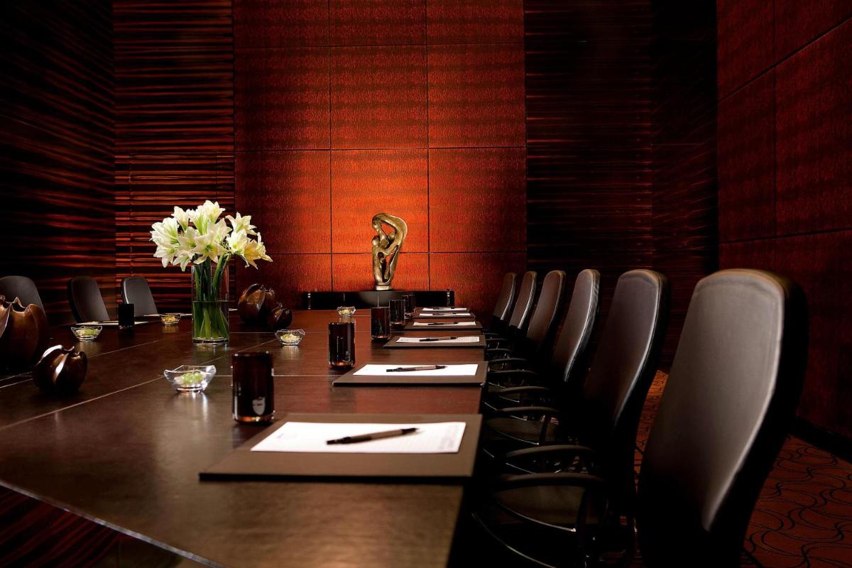 a conference room with a long table and chairs at JW Marriott Pune in Pune