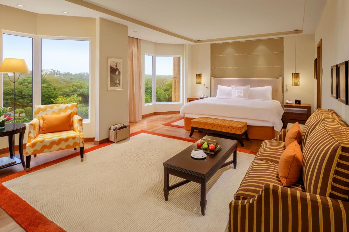 a large hotel room with a bed and a couch at ITC Maurya, a Luxury Collection Hotel, New Delhi in New Delhi a large hotel room with a bed and a couch at ITC Maurya, a Luxury Collection Hotel, New Delhi in New Delhi
