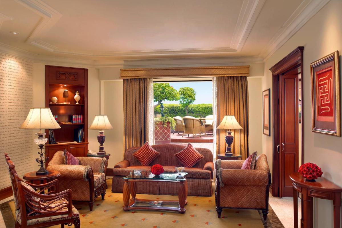 a living room with a couch and chairs and a window at ITC Maurya, a Luxury Collection Hotel, New Delhi in New Delhi a living room with a couch and chairs and a window at ITC Maurya, a Luxury Collection Hotel, New Delhi in New Delhi
