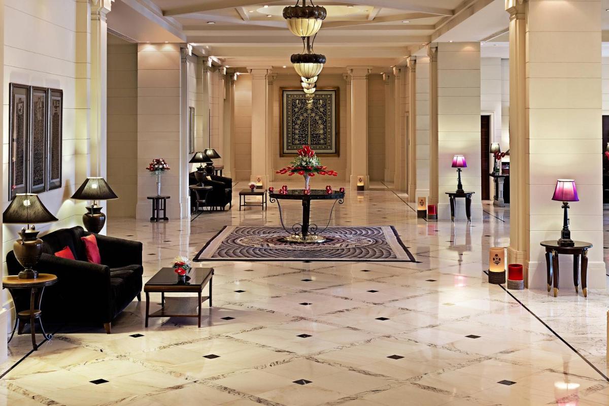 a lobby of a hotel with a table and chairs at ITC Kakatiya, a Luxury Collection Hotel, Hyderabad in Hyderabad