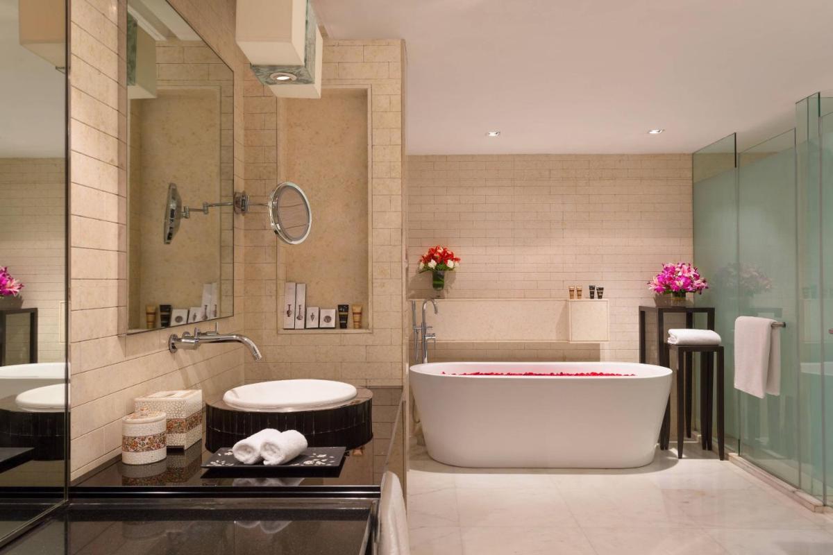 a bathroom with a tub and two sinks at ITC Kakatiya, a Luxury Collection Hotel, Hyderabad in Hyderabad