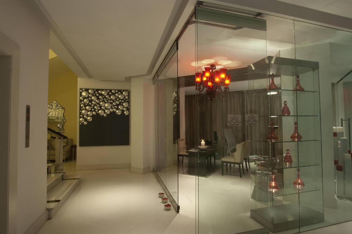 a glass display case in a room with a table at ITC Kakatiya, a Luxury Collection Hotel, Hyderabad in Hyderabad
