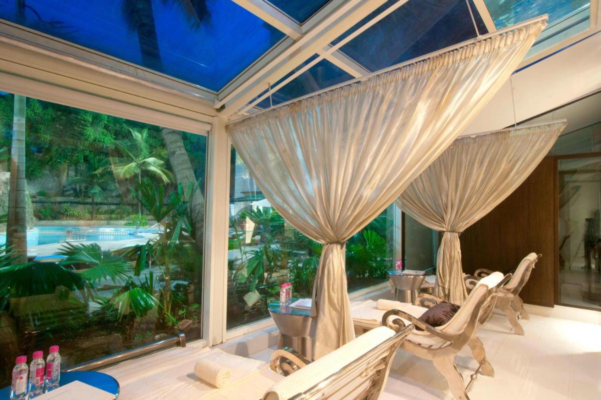 a room with two chairs and a large window at ITC Kakatiya, a Luxury Collection Hotel, Hyderabad in Hyderabad