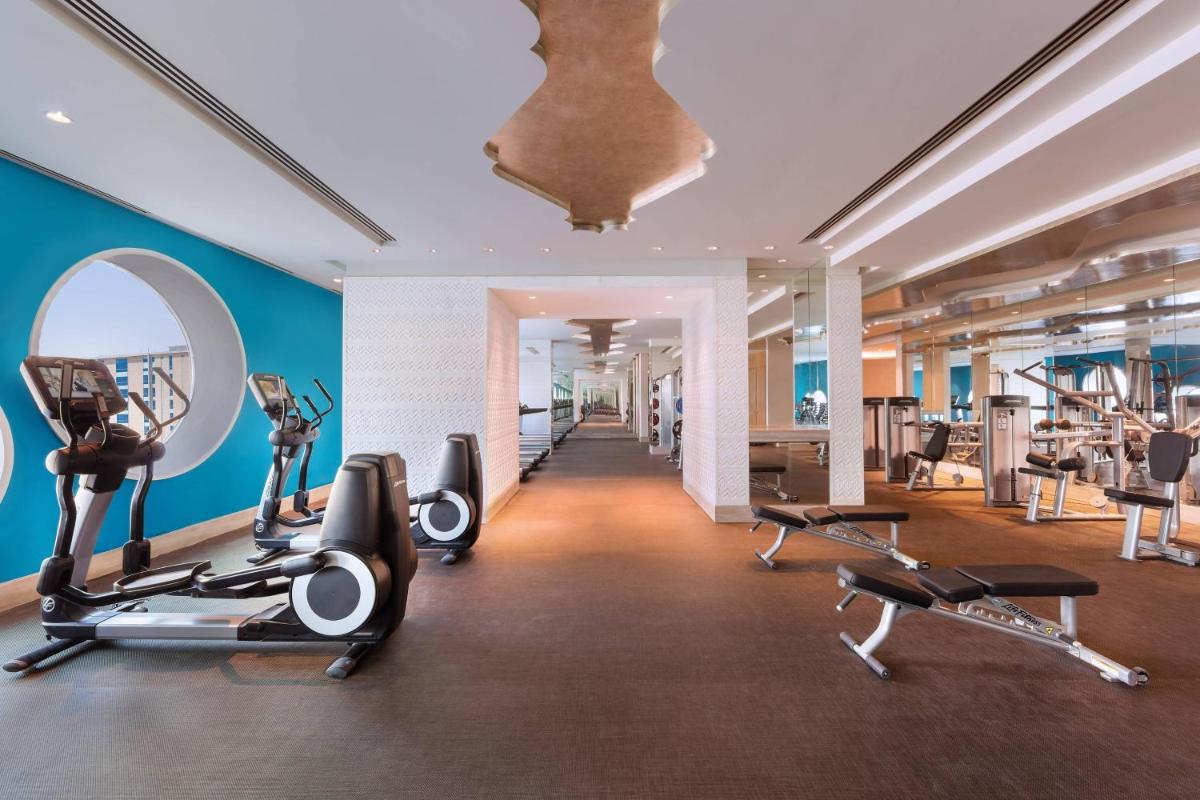 a gym with treadmills and cardio equipment in a building at ITC Kohenur, a Luxury Collection Hotel, Hyderabad in Hyderabad