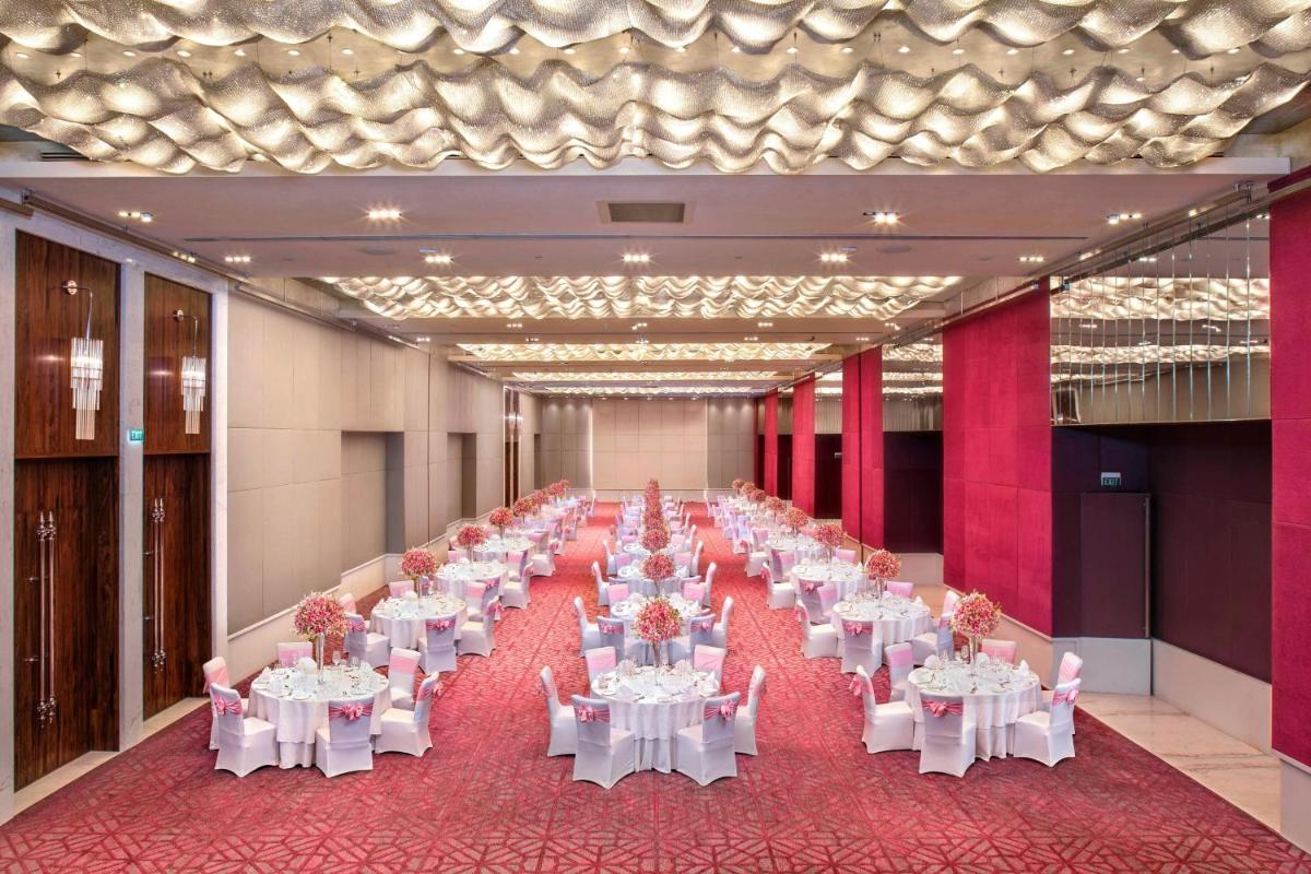 a large banquet hall with white tables and chairs at ITC Kohenur, a Luxury Collection Hotel, Hyderabad in Hyderabad