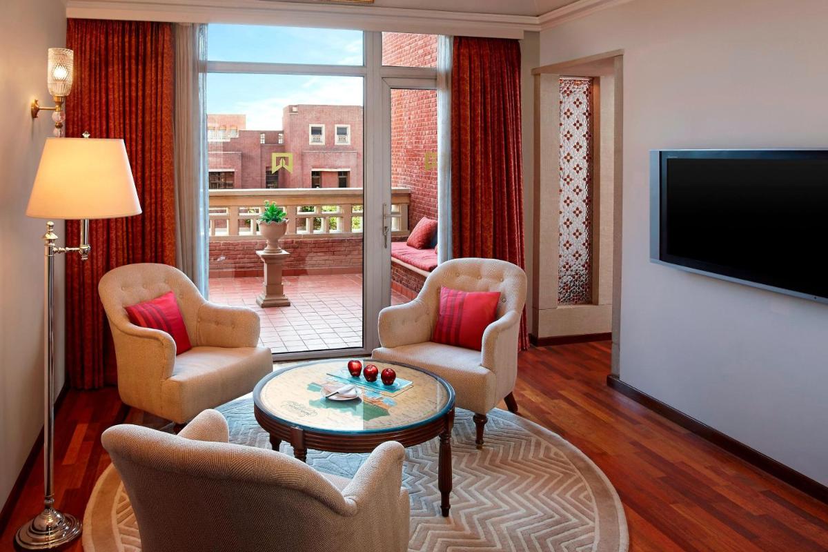 a living room with chairs and a flat screen tv at ITC Rajputana, a Luxury Collection Hotel, Jaipur in Jaipur