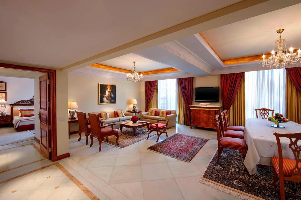 a living room with a dining table and a living room at ITC Rajputana, a Luxury Collection Hotel, Jaipur in Jaipur