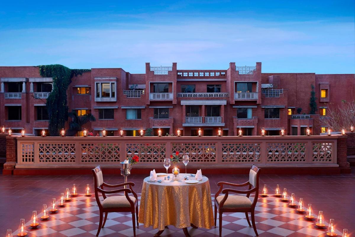 a table with chairs and candles in front of a building at ITC Rajputana, a Luxury Collection Hotel, Jaipur in Jaipur