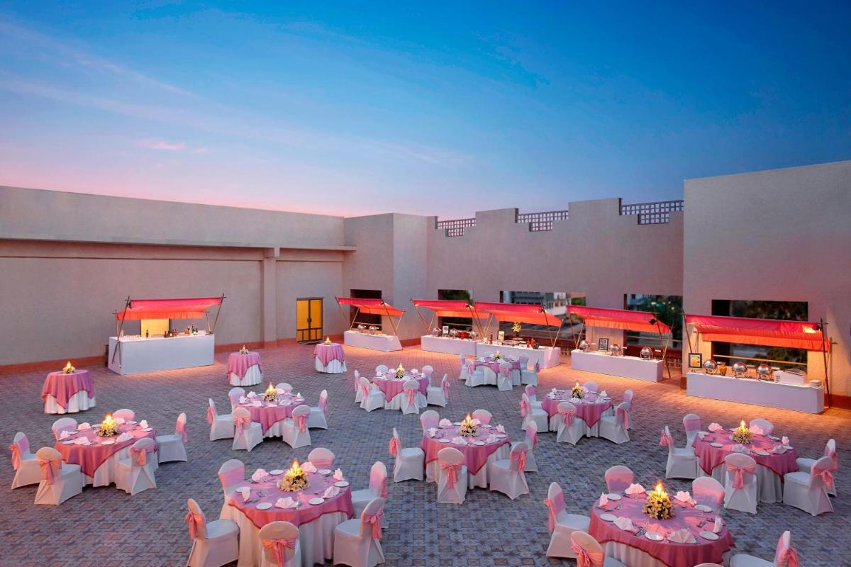 a banquet hall with pink tables and white chairs at ITC Rajputana, a Luxury Collection Hotel, Jaipur in Jaipur