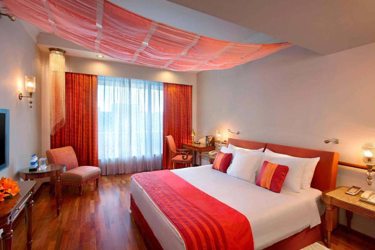 a hotel room with a large bed and a desk at ITC Rajputana, a Luxury Collection Hotel, Jaipur in Jaipur