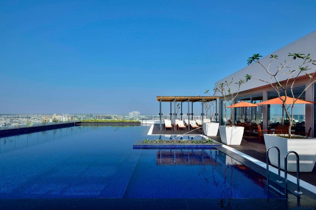a swimming pool on the roof of a building at Marriott Executive Apartments Hyderabad in Hyderabad