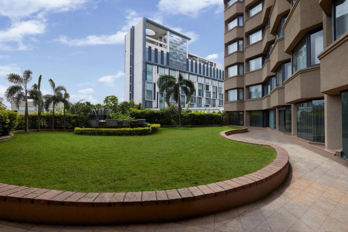 a park in front of a building at Hyderabad Marriott Hotel & Convention Centre in Hyderabad