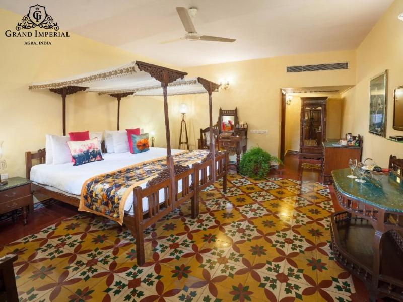 a bedroom with a large bed and a rug at The Grand Imperial - Heritage Hotel in Agra