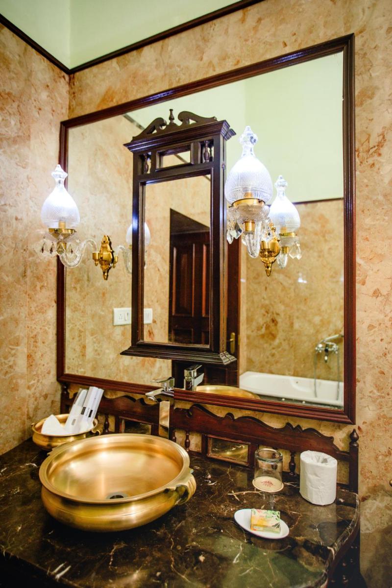 a bathroom with a sink and a large mirror at The Grand Imperial - Heritage Hotel in Agra
