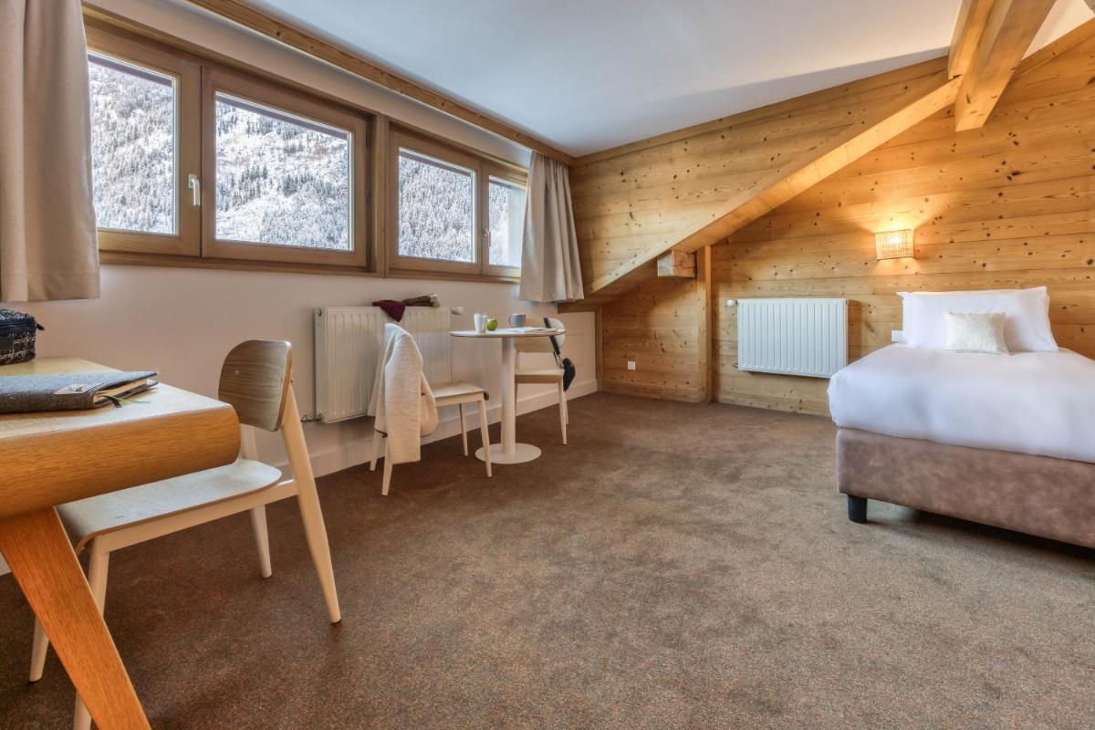 Un ou plusieurs lits dans un hébergement de l'établissement Hôtel Lyret