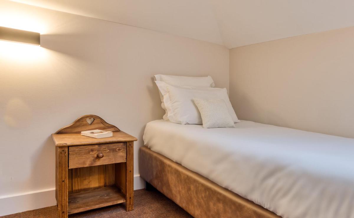 Un ou plusieurs lits dans un hébergement de l'établissement Hôtel Lyret