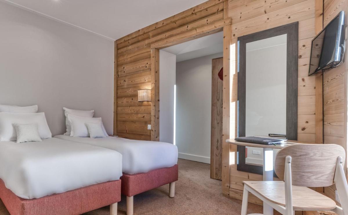 Un ou plusieurs lits dans un hébergement de l'établissement Hôtel Lyret