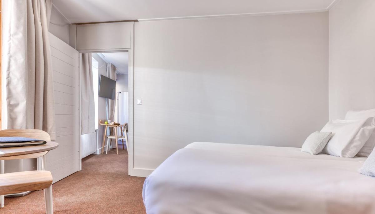 Un ou plusieurs lits dans un hébergement de l'établissement Hôtel Lyret