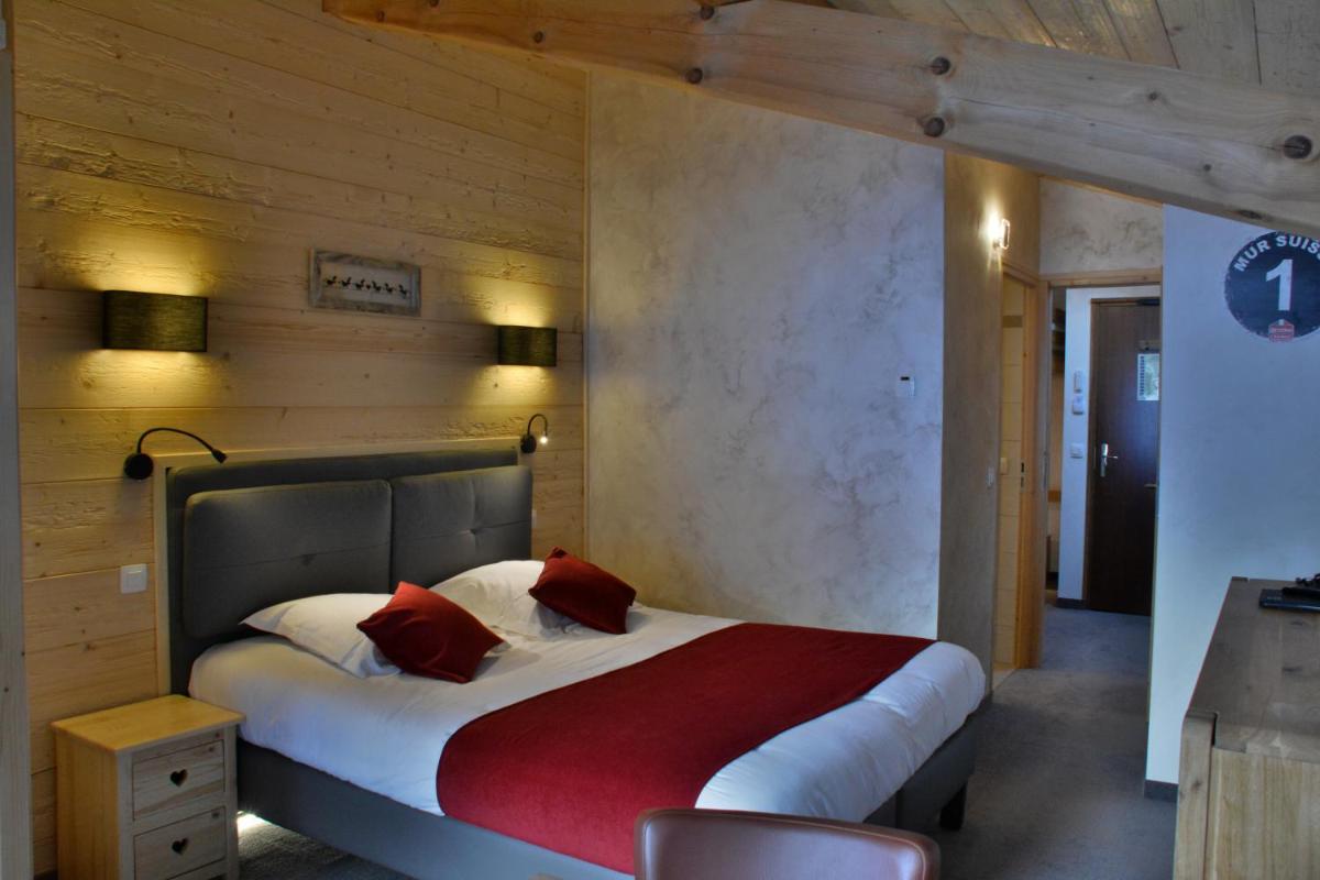 Un ou plusieurs lits dans un hébergement de l'établissement Hôtel Les Côtes, Résidence Loisirs et Chalets