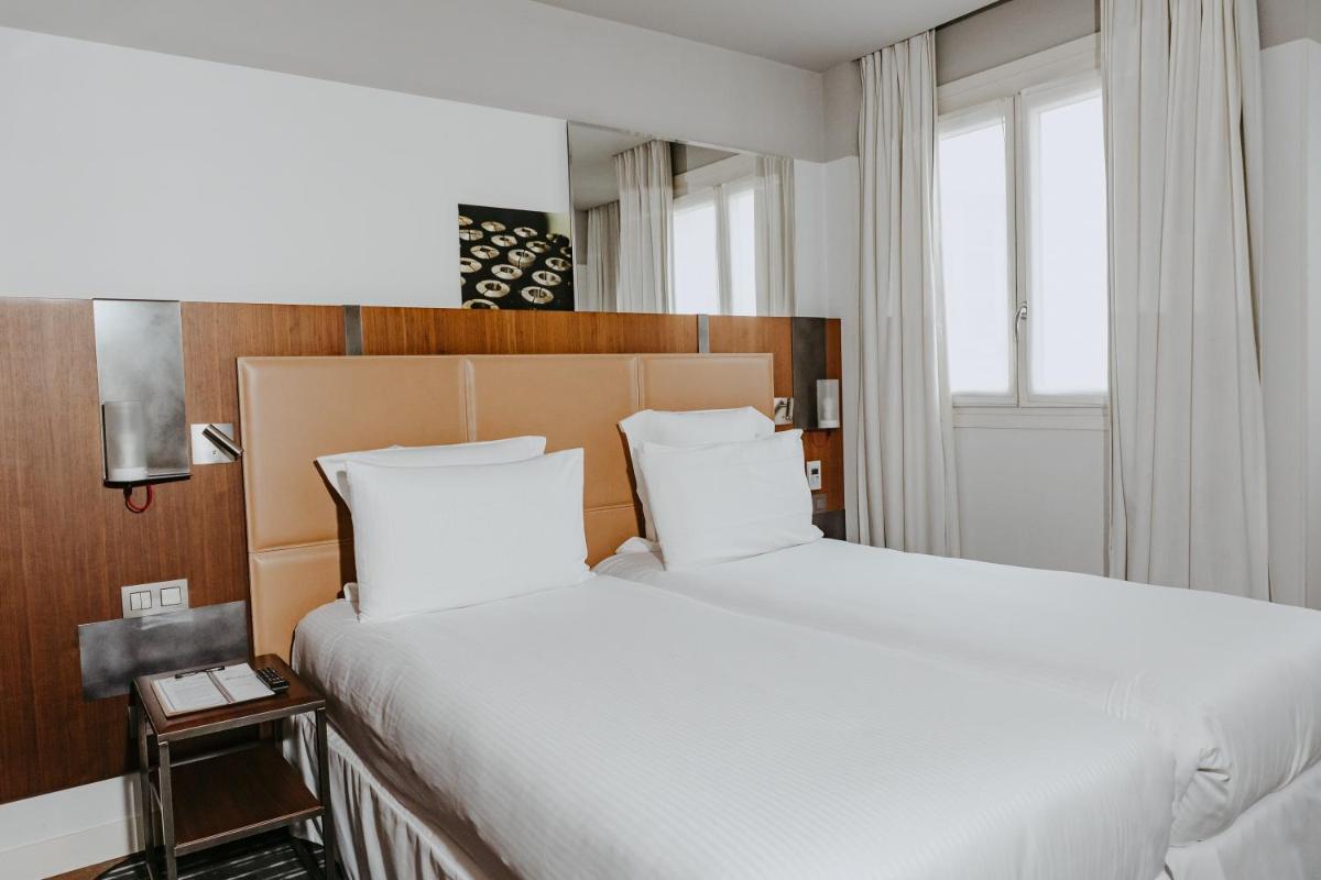 Un ou plusieurs lits dans un hébergement de l'établissement Boutet Bastille Hotel Paris - MGallery Collection