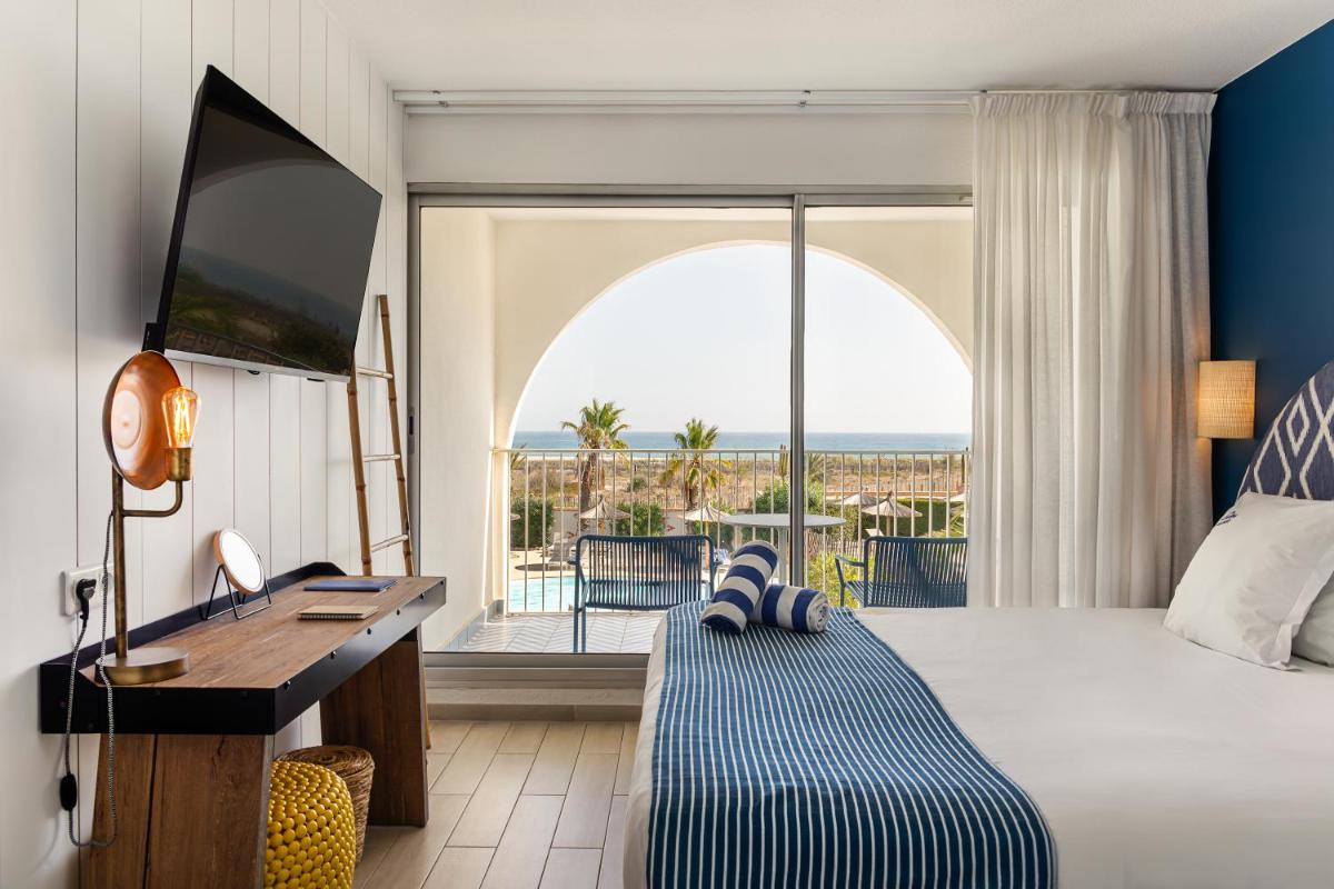 Un ou plusieurs lits dans un hébergement de l'établissement Les Bulles de Mer - Hotel & Spa sur la Plage