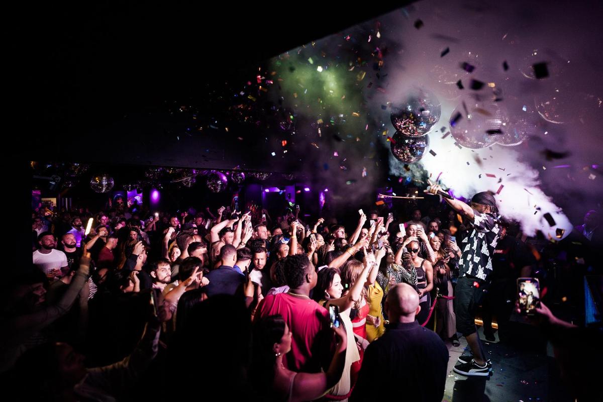 a crowd of people at a concert with a dj at FIVE Palm Jumeirah Dubai in Dubai