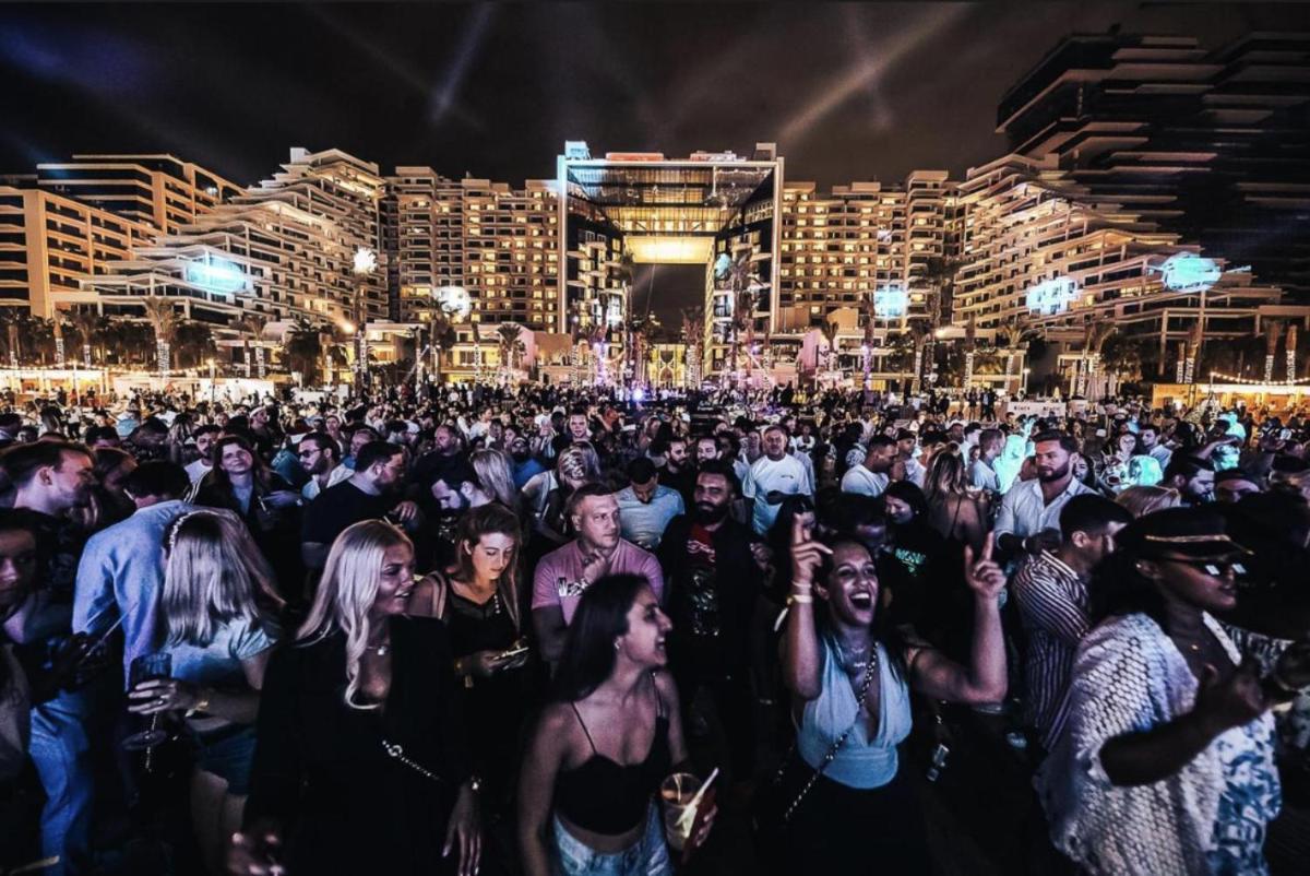 a crowd of people at a party at night at FIVE Palm Jumeirah Dubai in Dubai