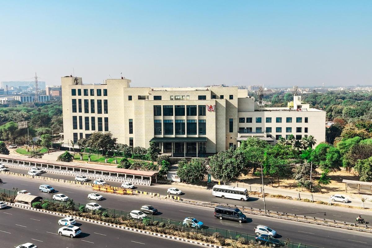 a large building with a road in front of it at Welcomhotel by ITC Hotels, Delhi-Gurugram Highway in New Delhi