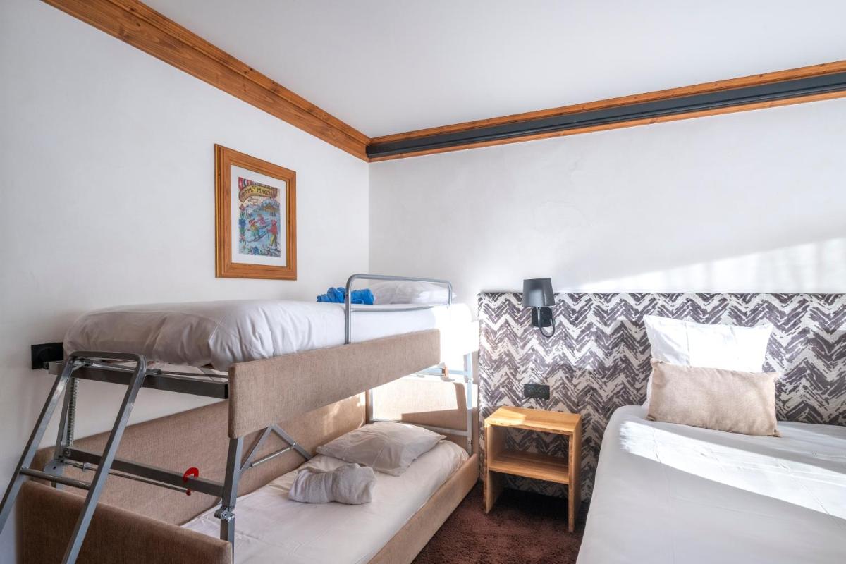 Un ou plusieurs lits dans un hébergement de l'établissement Hôtel Macchi Restaurant & Spa
