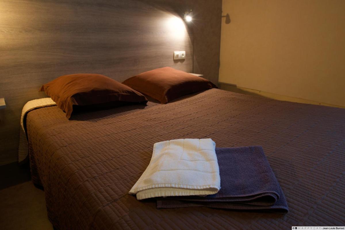 Un ou plusieurs lits dans un hébergement de l'établissement Hôtel La Tente Verte
