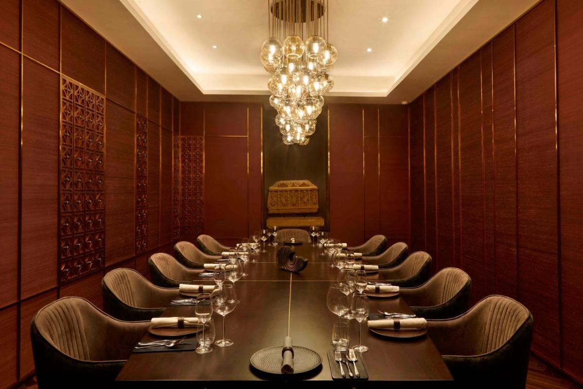 a long dining room with a long table and chairs at JW Marriott Mumbai Juhu in Mumbai