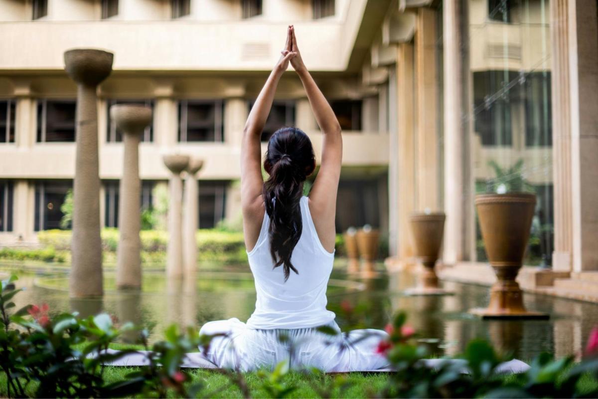 a woman doing a yoga pose in the water at JW Marriott Mumbai Juhu in Mumbai