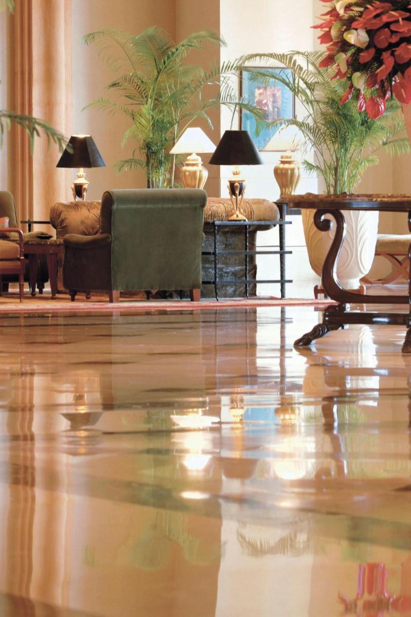 a living room with furniture and a shiny floor at JW Marriott Mumbai Juhu in Mumbai