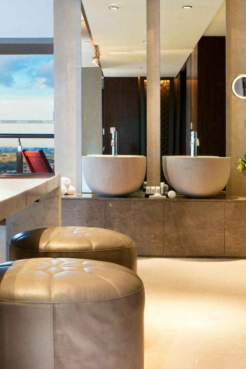 a bathroom with two sinks and two toilets at The Westin Hyderabad Mindspace in Hyderabad